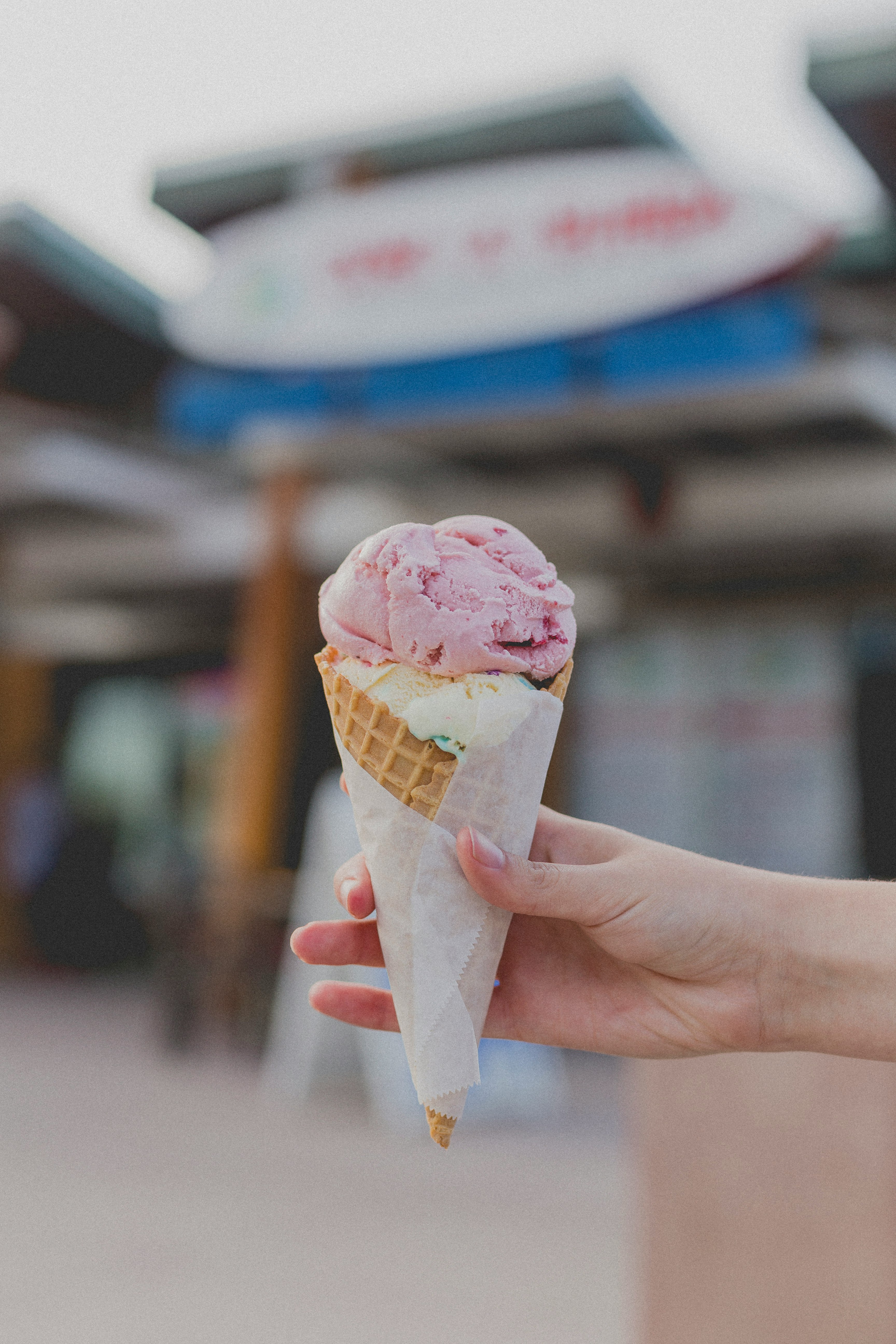 person holding strawberry ice cream